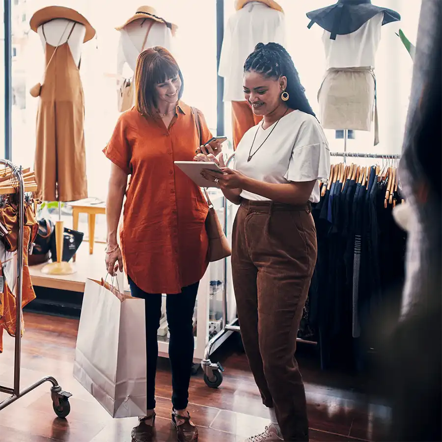 Store associate assisting a customer in a fashion store using a mobile POS